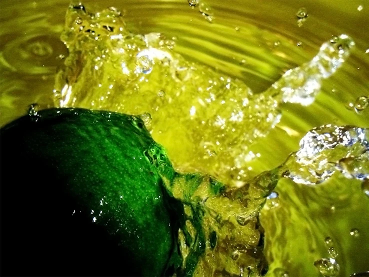 a green liquid splashing into a sink