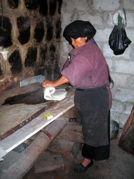 the woman is working on a piece of machinery