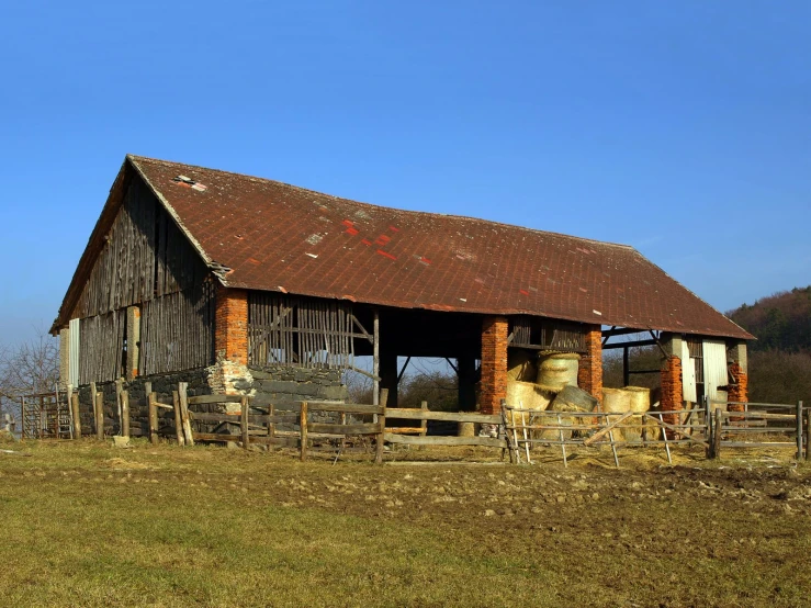 the old barn has been partially gone and sits empty