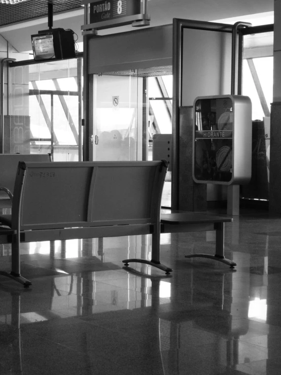 an empty bench in the middle of the airport