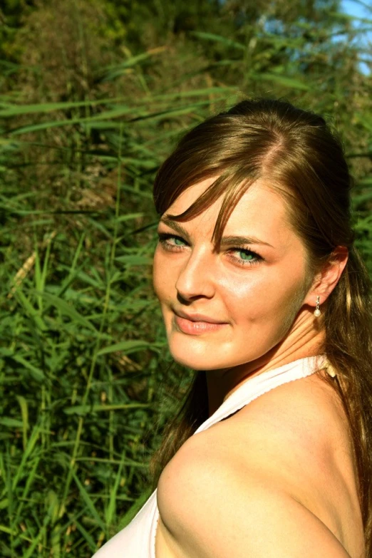 young woman in green grass on sunny day