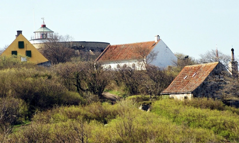 a view of several houses on top of a hill