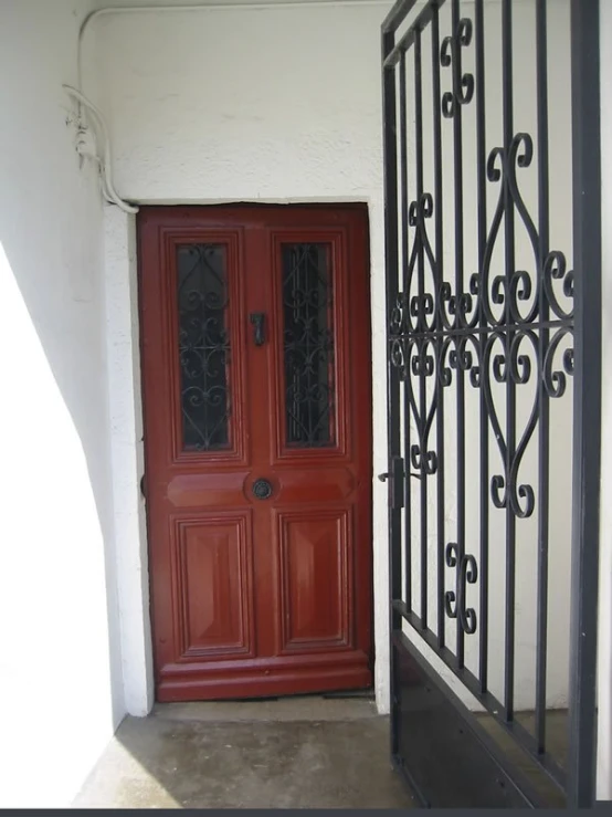 a red door is on a white building