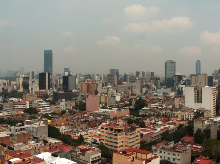 a city filled with tall buildings under cloudy skies