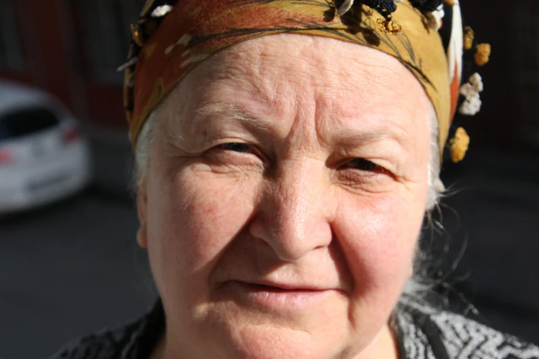 an old woman is posing with her face slightly closed