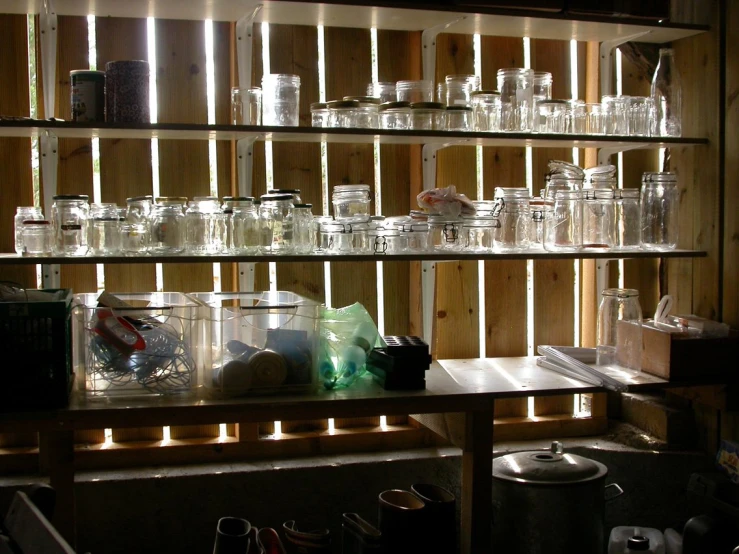 a bunch of jars that are sitting on shelves