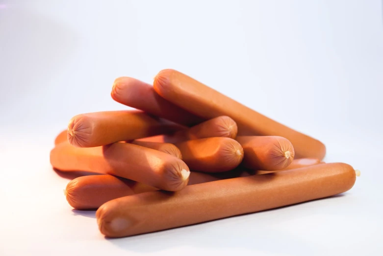 a group of  dogs with multiple sausages on them