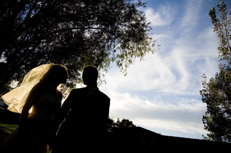 a bride and groom walking away from the wedding party