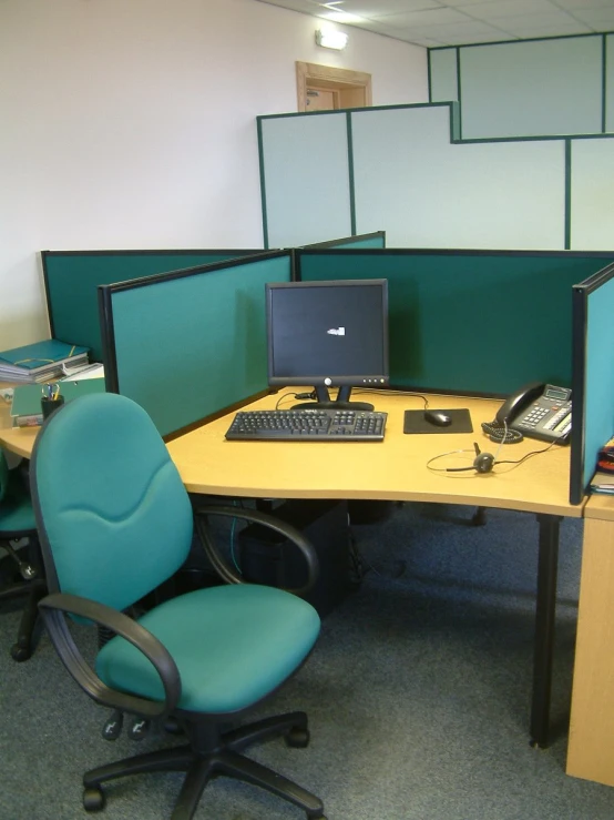 a desk with computer and two chairs around it