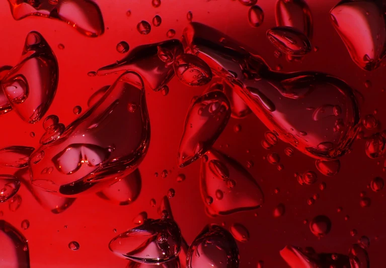 a picture of some water droplets on red paper