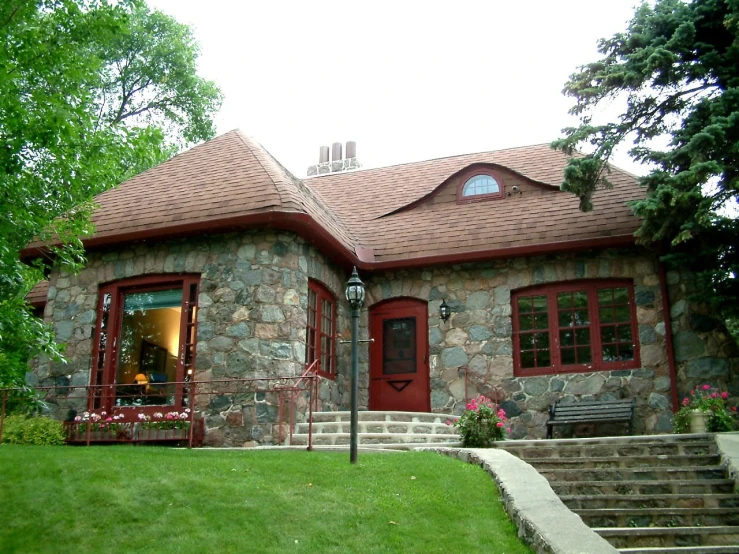 an outside view of a building with windows, grass and a staircase