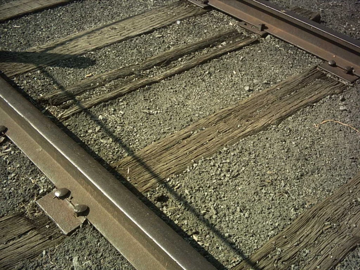 the train tracks have different rail lines and have many rusted sections