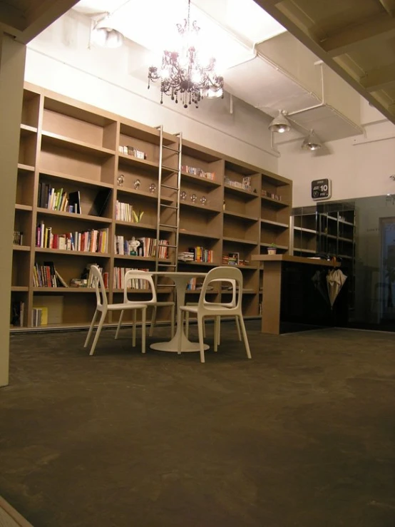 chairs and tables sit in a liry while an arched light hangs from the ceiling