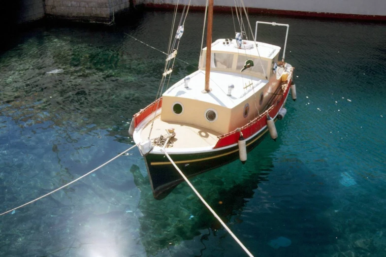a red and white boat in the water