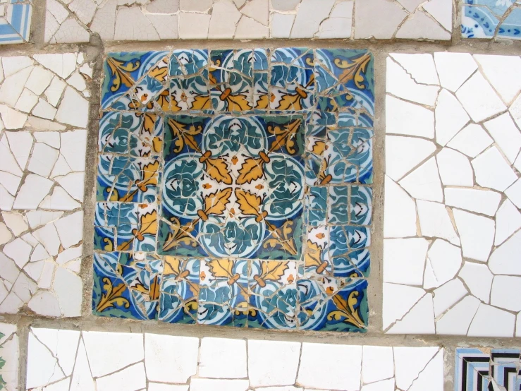 decorative tile displayed on white wall with blue and yellow tile