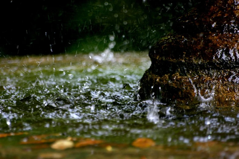 a water fountain is flowing down a green yard