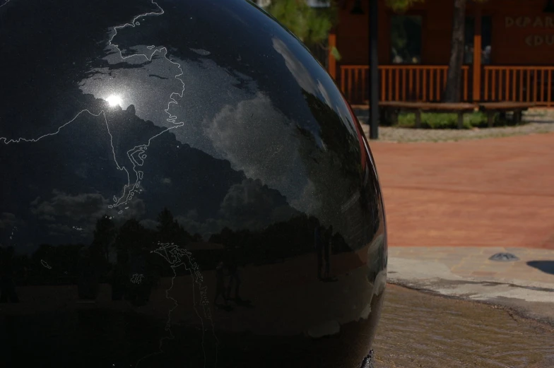 a black sculpture on display in the park