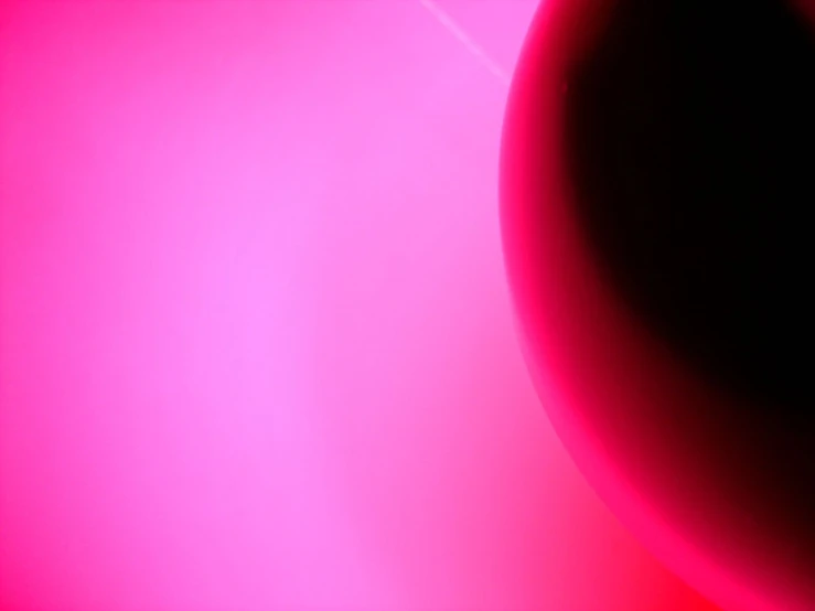 a dark red colored background with a blurry circle