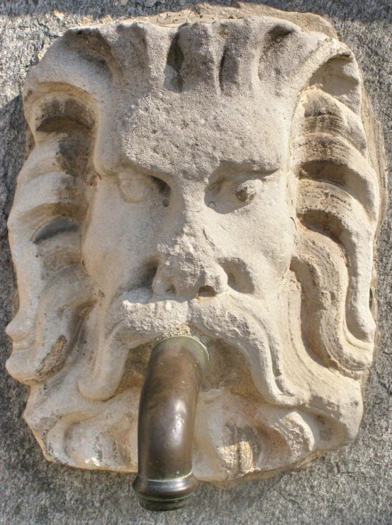 a close up of an old statue on cement