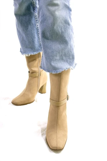 a woman with long jeans is wearing booties