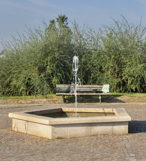 an old fountain sitting on top of a stone slab