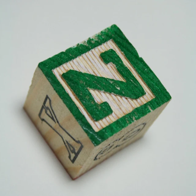 a wooden dice with a wooden sign on the front