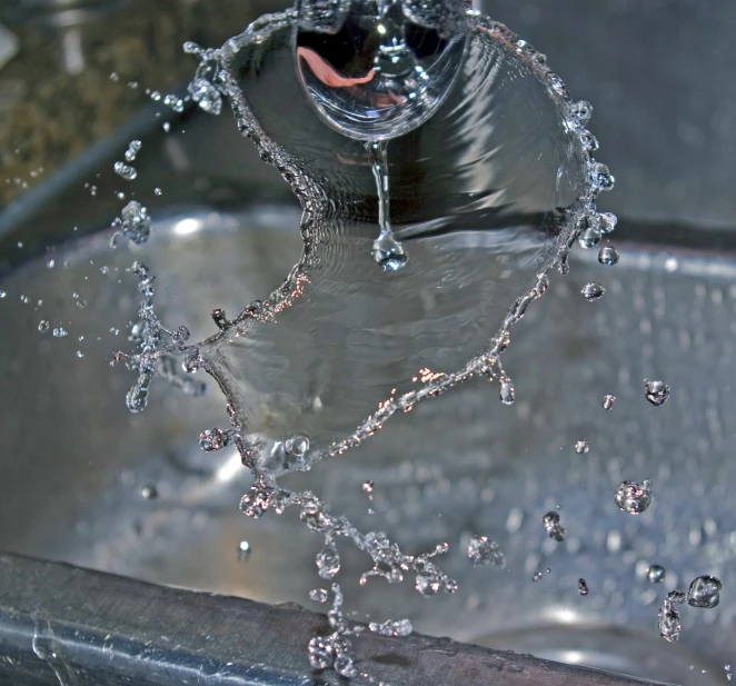 this is a sink that has water coming from the faucet