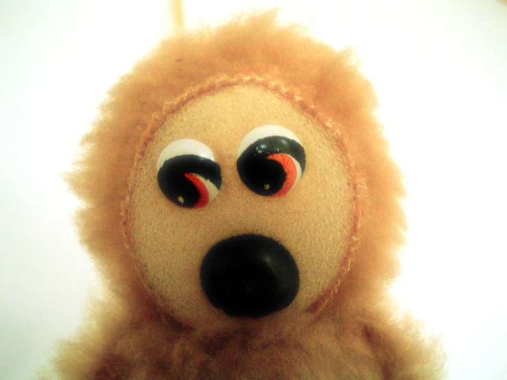 an odd looking stuffed animal with googly eyes