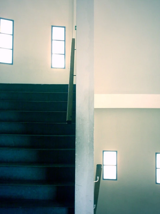 a set of stairs with three windows near each other