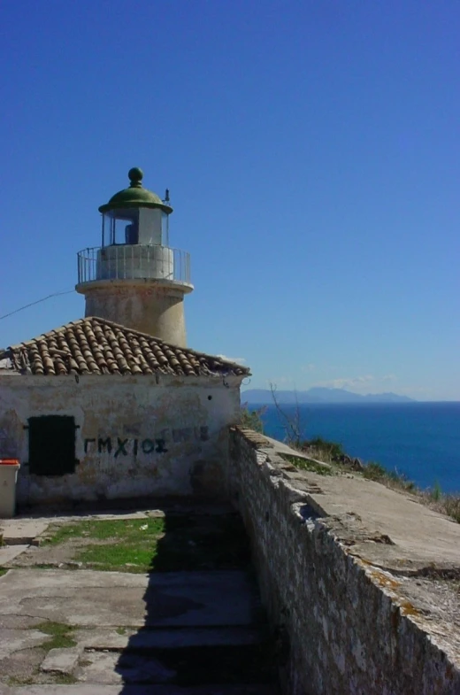 a stone building with a white light house