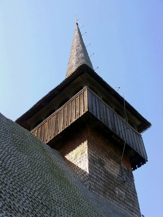 looking up at a wooden structure with a light on top
