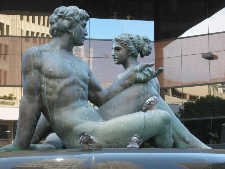 a very pretty sculpture of two guys by the pool