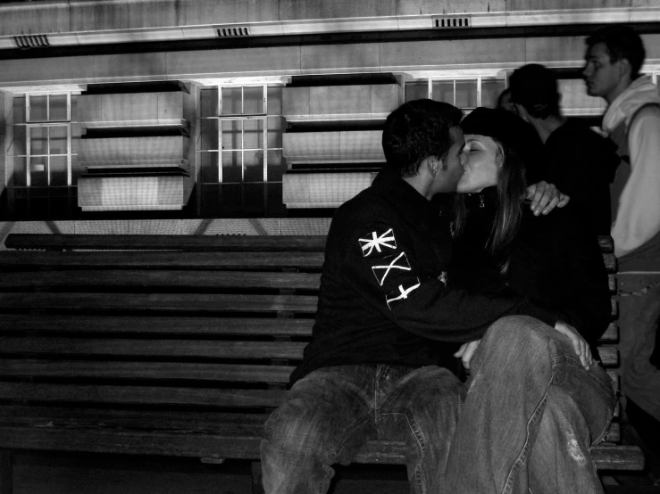 two people sitting on a bench at an airport