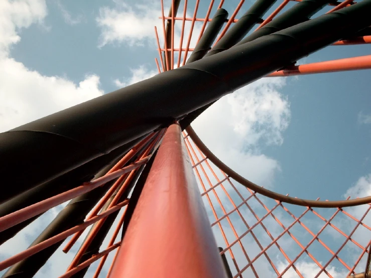 view from below looking up at the side of a red and black structure