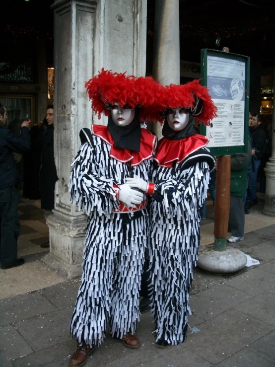 two people in animal print outfits posing for a po