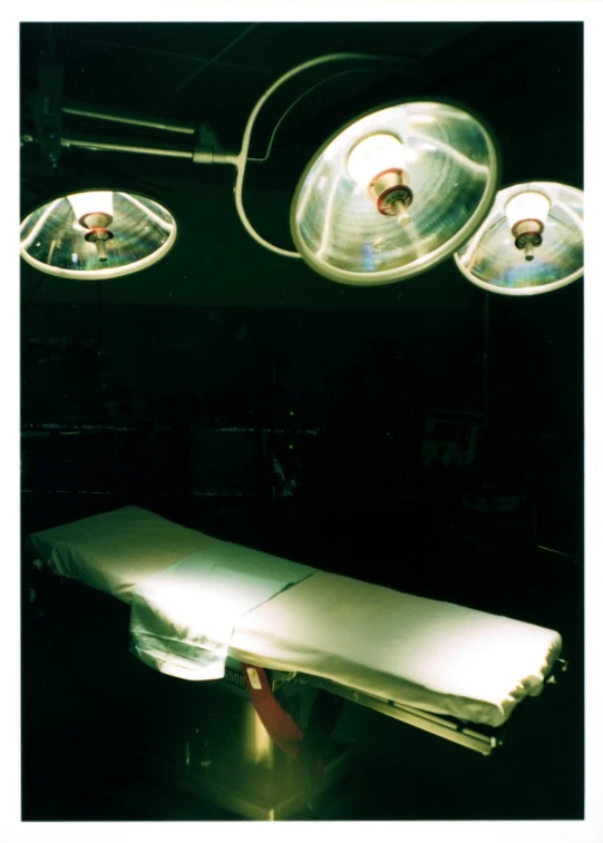 lights are above a hospital bed that is being used as a lighting source