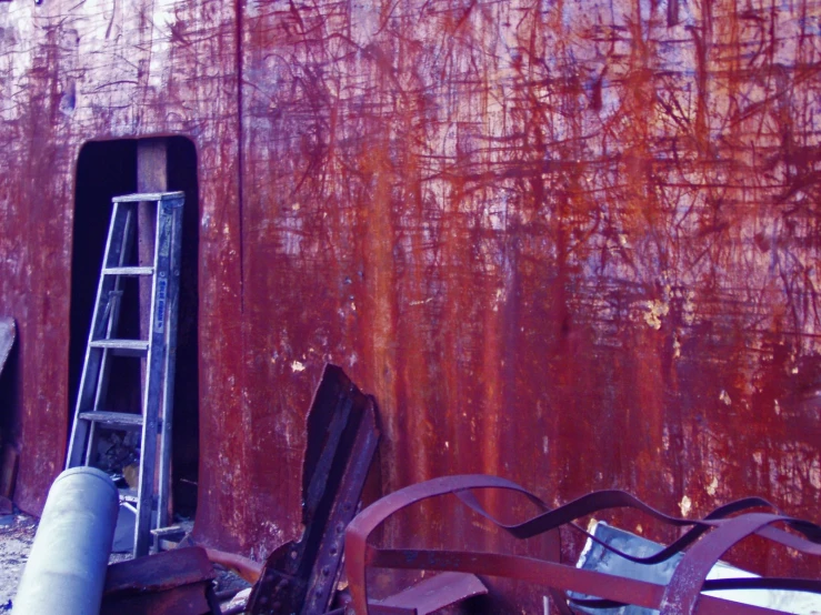 an old rusted metal structure with some ladders