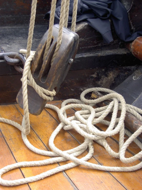 a pile of ropes hanging on top of a boat