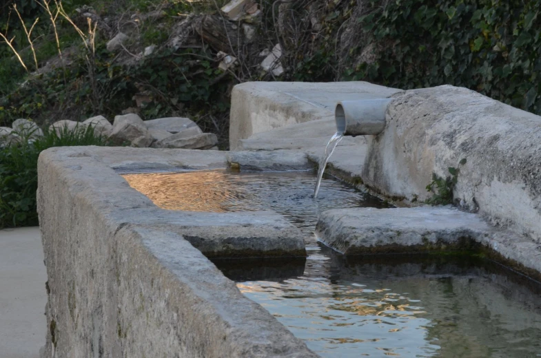 a water feature in an outdoor stone park