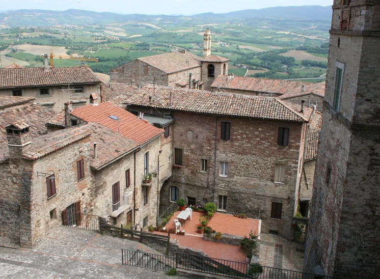 an old looking city in the countryside with old stone houses