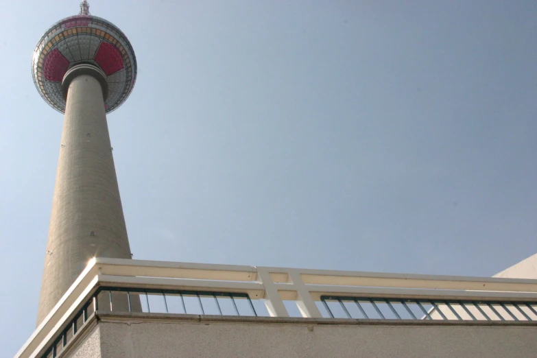 the tall tower has a red and white top