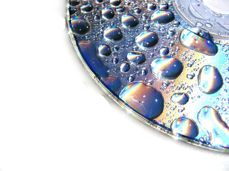 water drops are reflecting the reflection of the disc