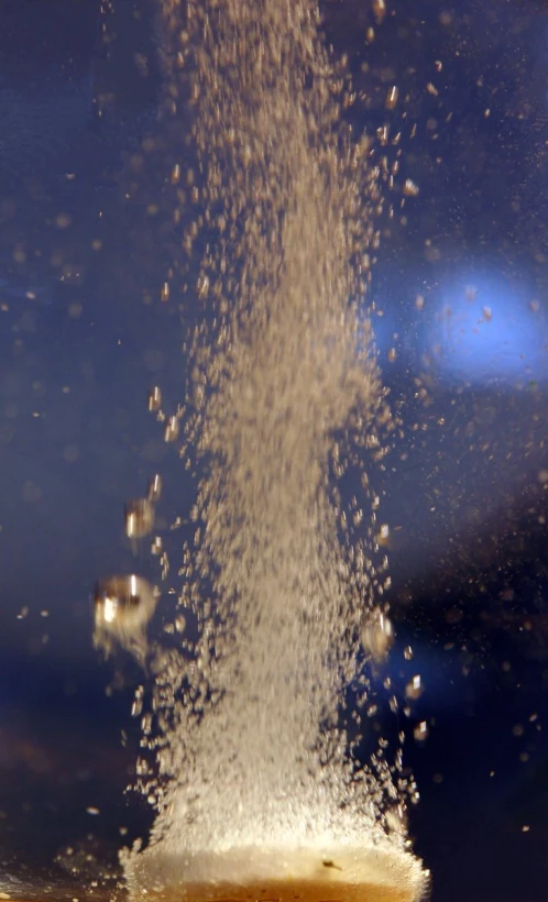 some water falling off the top of a faucet