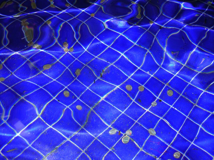 water and gold dots on a blue swimming pool