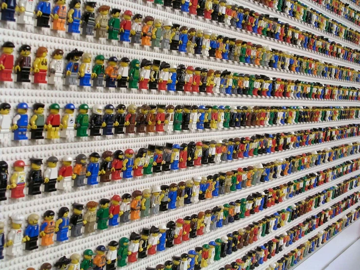 a wall filled with lots of lego minifigures