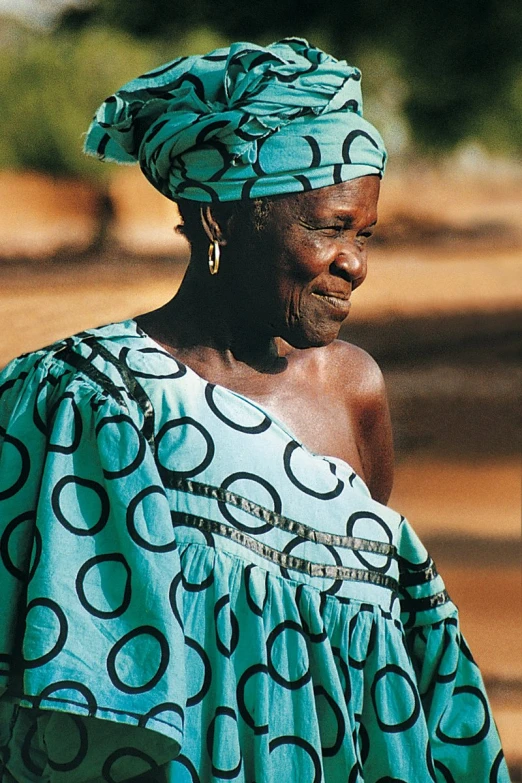 a woman standing on top of a dirt road