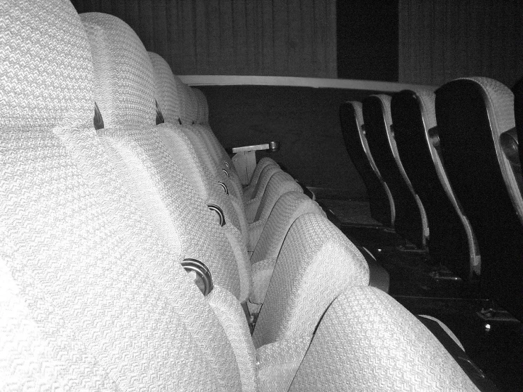 someone wearing black and white clothes resting his head on the back of a bench