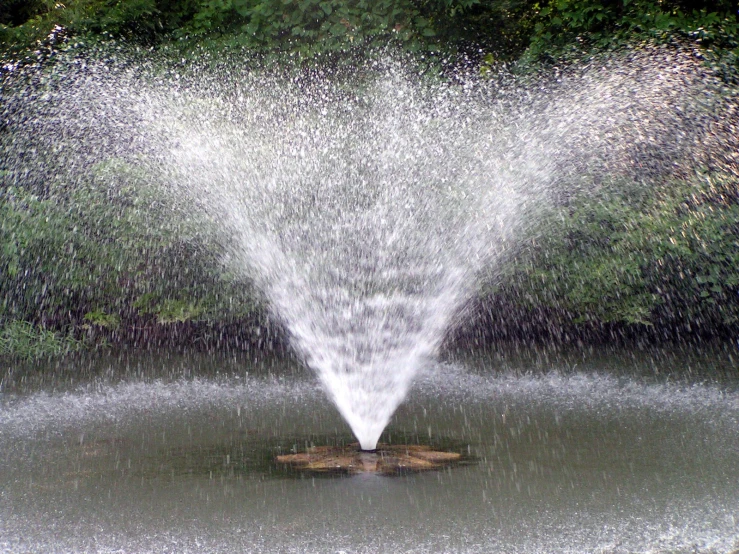 water shoots from the top of an open water spout