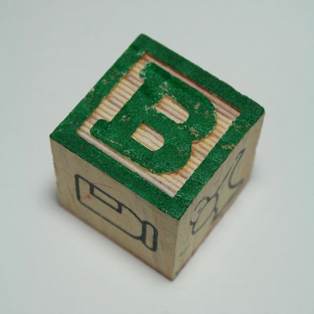 a wooden blocks of some sort with the letter b in it