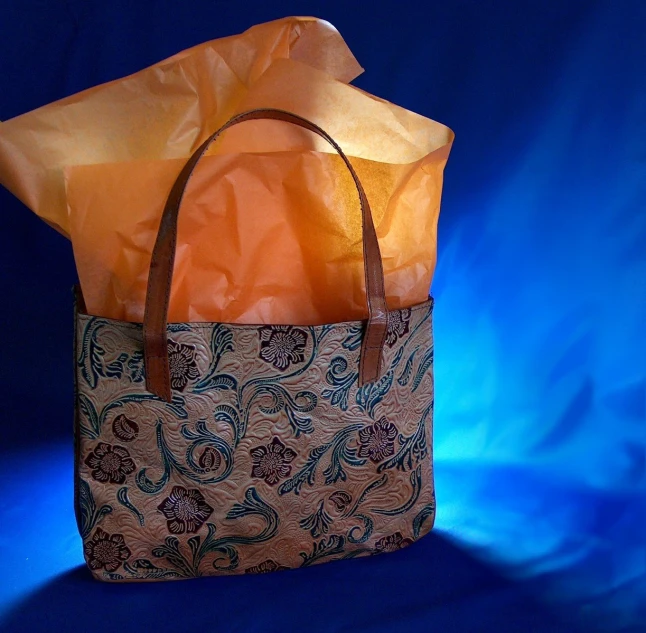 an orange shopping bag with floral fabric